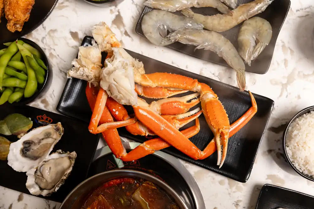 Snow crab legs, shrimp and oysters ready for the clear broth